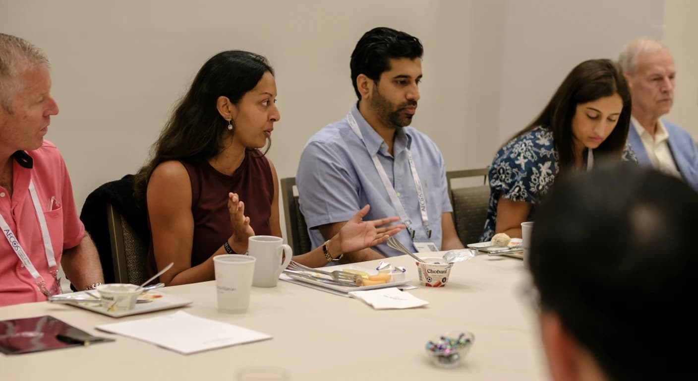 Eye care professionals in discussion around a table at an Eyeprentice meeting